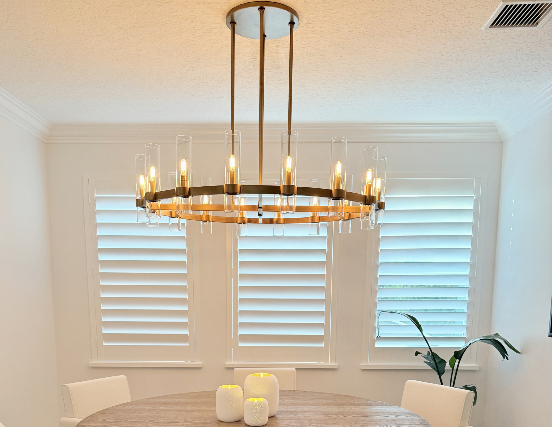 Custom wood plantation shutters installed in dining room windows in Palm Beach Gardens home