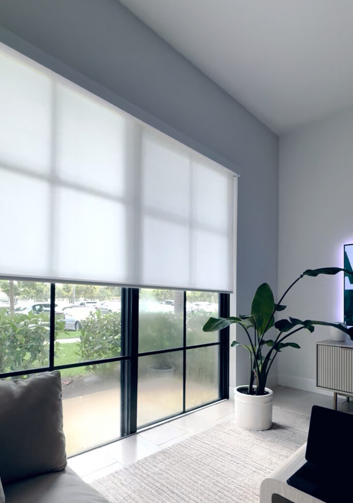 Light filtering roller shades installed on large living room windows